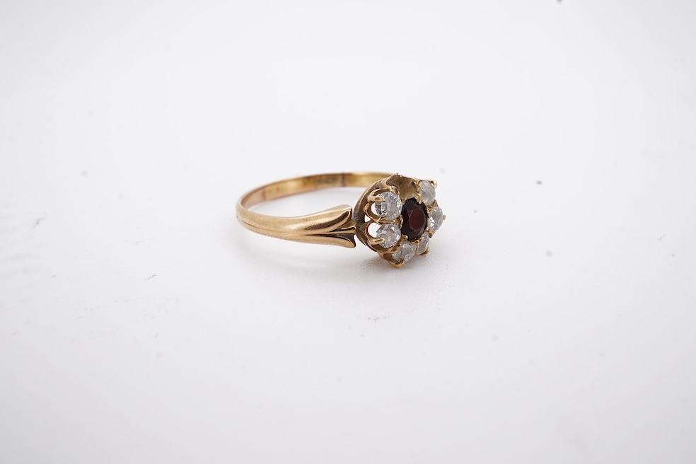 A yellow metal, garnet? and diamond set circular cluster ring (one stone missing), size P, gross weight 3 grams. Condition - poor